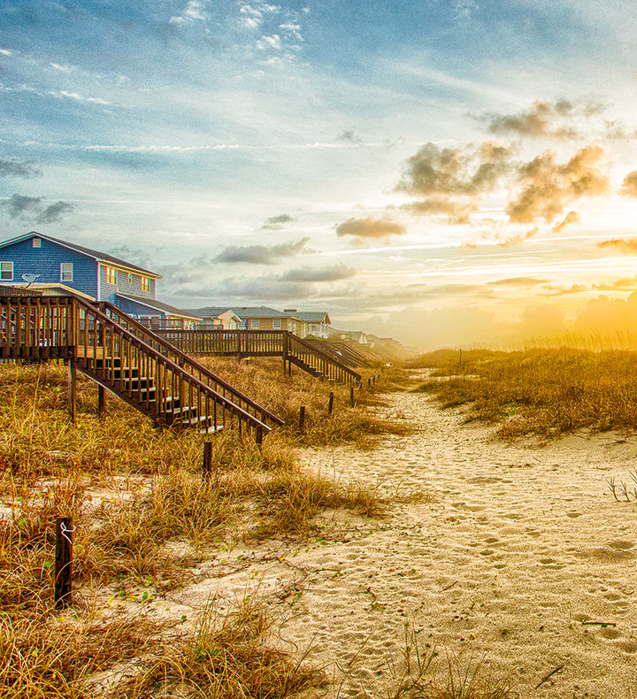 Breathtaking Coastal Landscape with Oceanfront Vacation Rentals on Oak Island at Sunrise